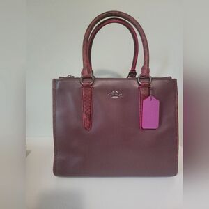 Coach satchel in oxblood leather with snake embossed trim. H-8.5 W 10.25in